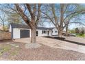 View of the home's charming exterior, featuring a driveway and gravel, as well as professional landscaping at 4625 Webster St, Wheat Ridge, CO 80033