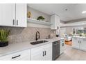 Bright kitchen with new stainless steel appliances, white countertops and cabinets at 4625 Webster St, Wheat Ridge, CO 80033