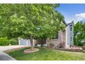 Beautiful home with brick and siding exterior, mature tree, and well-maintained front yard at 8927 Green Meadows Ln, Highlands Ranch, CO 80126