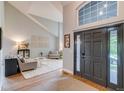 Inviting living room features high ceilings and ample natural light from the large arched window at 8927 Green Meadows Ln, Highlands Ranch, CO 80126