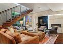 Inviting living room with modern staircase, bright window, plush seating, and stylish decor at 865 Delaware St, Denver, CO 80204