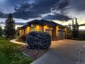 Spacious three-car garage with an expansive driveway and manicured landscaping at 5441 Twilight Way, Parker, CO 80134