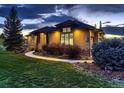 Beautiful home with stone details, manicured lawn, and a winding walkway at 5441 Twilight Way, Parker, CO 80134