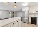Open concept: view of the kitchen featuring a stainless steel refrigerator and breakfast bar at 9150 E Center Ave # 9C, Denver, CO 80247