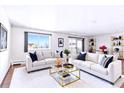 Bright and spacious living room with hardwood floors, couches and a glass coffee table at 9150 E Center Ave # 9C, Denver, CO 80247