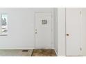 Bright entryway with a textured door, neutral walls and carpet at 2767 S Linley Ct, Denver, CO 80236