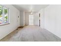 Spacious living room with neutral carpet, bright natural light, and an open layout at 2767 S Linley Ct, Denver, CO 80236