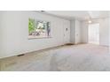 Spacious living room with neutral carpet, bright natural light, and an open layout at 2767 S Linley Ct, Denver, CO 80236
