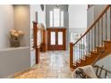 Inviting foyer with tile flooring, natural light, and elegant wood accents at 9009 Rambling Oak Pl, Parker, CO 80134