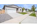 Well maintained home with a two car garage, a concrete driveway, and a newly installed sprinkler system at 819 Sunflower Dr, Brighton, CO 80601