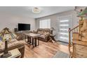 Inviting living room features hardwood floors, a plush sofa, and abundant natural light at 4694 S Ouray Way, Aurora, CO 80015