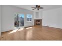 Bright living room with a ceiling fan, fireplace and access to a deck at 1552 Live Oak Rd, Castle Rock, CO 80104