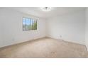 Spacious bedroom with neutral carpet, a large window for natural light, and ample space at 757 Norfolk Way, Aurora, CO 80011