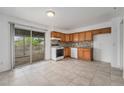 Functional kitchen with classic cabinets, tile backsplash, and a sliding door to the deck at 757 Norfolk Way, Aurora, CO 80011