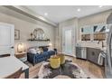 Cozy living room with a blue sofa, industrial style shelf, and decorative mirror and furnishings at 3219 W 19Th Ave # 4, Denver, CO 80204