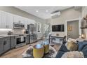 Bright, open-concept living space with stainless steel appliances, stairs, and modern furniture at 3219 W 19Th Ave # 4, Denver, CO 80204