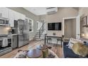 Bright living space with stainless appliances, stairs, modern furniture and dining area at 3219 W 19Th Ave # 4, Denver, CO 80204