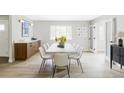 An elegantly staged dining room with neutral tones and seating for eight at 11762 W 34Th Ave, Wheat Ridge, CO 80033