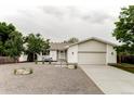 Charming single-story home with an inviting front yard, xeriscaping, mature trees, and a two-car garage at 11762 W 34Th Ave, Wheat Ridge, CO 80033