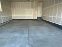 Spacious two-car garage with sealed concrete floors and a utility door at 16562 E 109Th Ave, Commerce City, CO 80022