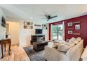 Spacious living area featuring hardwood floors, stylish decor, and a cozy sectional sofa at 19196 E Kansas Dr, Aurora, CO 80017