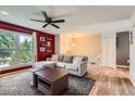 Bright living room with large window, comfortable seating, and modern ceiling fan at 19196 E Kansas Dr, Aurora, CO 80017