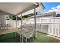 Covered outdoor patio area with seating and privacy fence at 2813 S Xanadu Way, Aurora, CO 80014