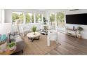 Open-concept living room with natural light, stylish decor, comfortable seating, and outdoor access at 5462 S Cedar St, Littleton, CO 80120