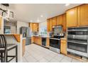 Modern kitchen with stainless steel appliances, ample cabinet space, and bar seating at 3046 S Alpine Dr, Evergreen, CO 80439