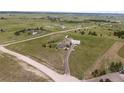 Expansive aerial view of a house and its large, well-maintained acreage, offering privacy and a rural lifestyle at 6785 Arrowhead Cir, Elizabeth, CO 80107