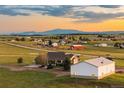 A view of the home and the surrounding area, with rolling fields and a picturesque mountain range in the distance at 6785 Arrowhead Cir, Elizabeth, CO 80107