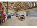 Spacious garage with high ceilings and ample storage space, ideal for hobbies, projects, or vehicle storage at 6785 Arrowhead Cir, Elizabeth, CO 80107