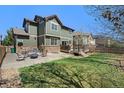 Spacious backyard with a patio, a fire pit, a lush lawn, ideal for outdoor entertaining at 24702 E Hoover Pl, Aurora, CO 80016