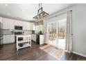 Bright kitchen with modern appliances, an island and a sliding glass door to the deck at 24702 E Hoover Pl, Aurora, CO 80016