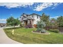 Well-maintained lawn with mature trees and shrubs framing this beautiful home at 2314 Fairway Wood Cir, Castle Rock, CO 80109