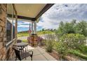 Covered porch with view of the street and neighborhood at 2314 Fairway Wood Cir, Castle Rock, CO 80109