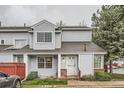 Charming two-story townhome with light blue siding, well-maintained landscaping, and a welcoming entrance at 12282 Bannock Cir # A, Denver, CO 80234