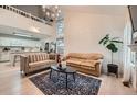 Open-concept living space featuring vaulted ceilings, hardwood floors, and stylish modern furniture at 12282 Bannock Cir # A, Denver, CO 80234