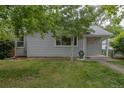 Quaint single-story home featuring a well-manicured lawn and mature trees at 3256 S Ogden St, Englewood, CO 80113