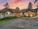 Attractive home exterior featuring a stone facade, multiple windows, and a landscaped front yard at 121 County Road 146, Elizabeth, CO 80107