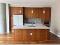 Modern kitchen with sleek wood cabinets, stainless steel appliances, and a large center island at 4200 W 17Th Ave # 411, Denver, CO 80204