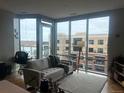 Inviting living room featuring large windows, plush sofa, and stylish decor providing a comfortable living space at 4200 W 17Th Ave # 411, Denver, CO 80204