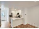The modern kitchen features white cabinetry, sleek countertops, and stainless steel appliances at 8197 S Fillmore Way, Centennial, CO 80122
