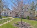 Beautifully landscaped front yard with mature tree and walkway leading to the home at 600 E Amherst Ave, Englewood, CO 80113
