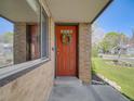 Inviting front entrance featuring a red door with a wreath, and brick facade at 600 E Amherst Ave, Englewood, CO 80113