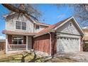 Charming two-story home features a brick facade and a two-car garage and a cozy front porch at 2791 S Bahama Ct, Aurora, CO 80013