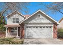 Charming two-story home featuring a brick facade, attached two-car garage, and covered front porch at 2791 S Bahama Ct, Aurora, CO 80013