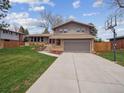A well-maintained home shows a spacious driveway and a basketball hoop in the yard at 9667 W Ohio Ave, Lakewood, CO 80226
