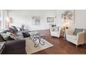Bright living room features hardwood floors, large windows, and stylish furnishings at 9667 W Ohio Ave, Lakewood, CO 80226