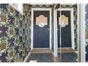 Entryway with mirrored closet doors and decorative floral wallpaper featuring pineapples at 2717 S Steele St, Denver, CO 80210